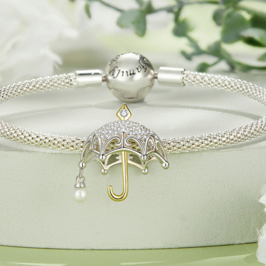 Hermoso charm de sombrilla con circonias dos tonos
